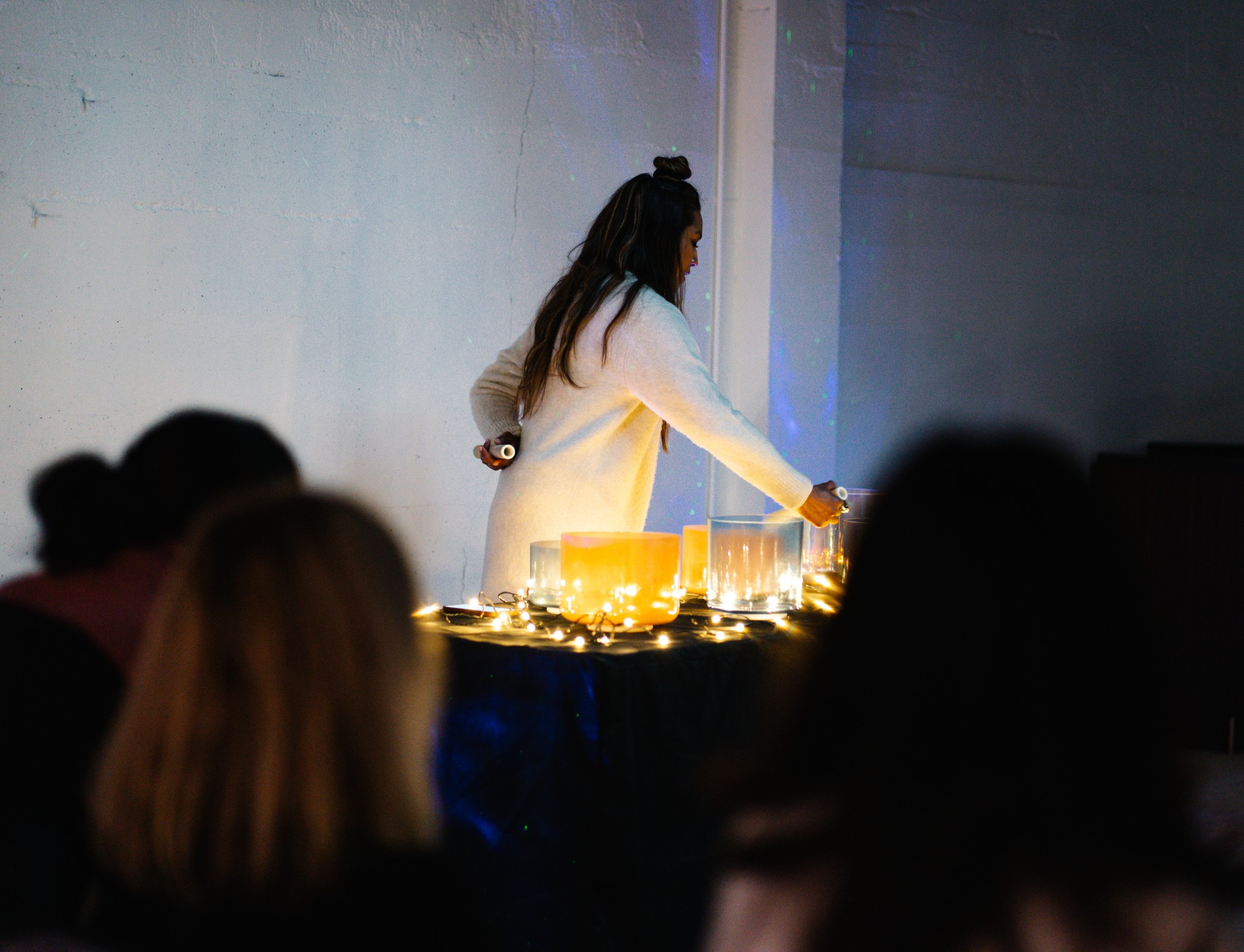 A candlelit sound bath — crystal singing bowls and string lights